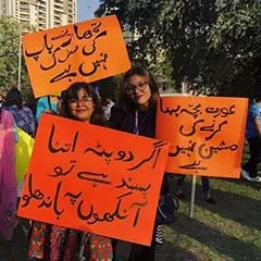 Women displaying placards during Aurat March 2019