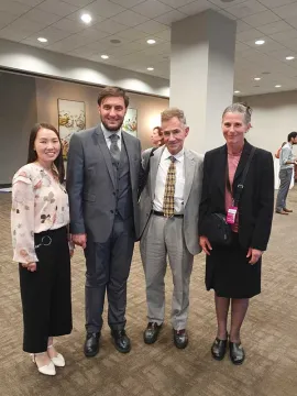 Amicarelli with Ambassador Grover Joseph Rees, Professor Holly Folk and a CAG parishioner