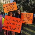 Women displaying placards during Aurat March 2019